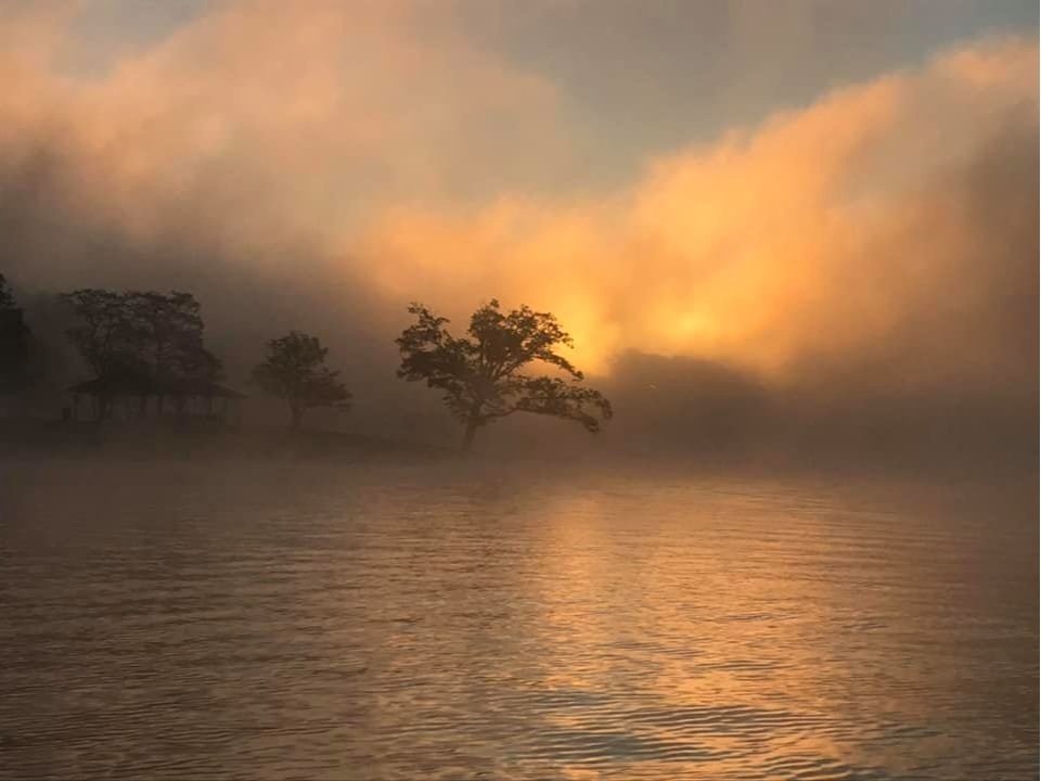 Golden mist rising off the lake at sunrise