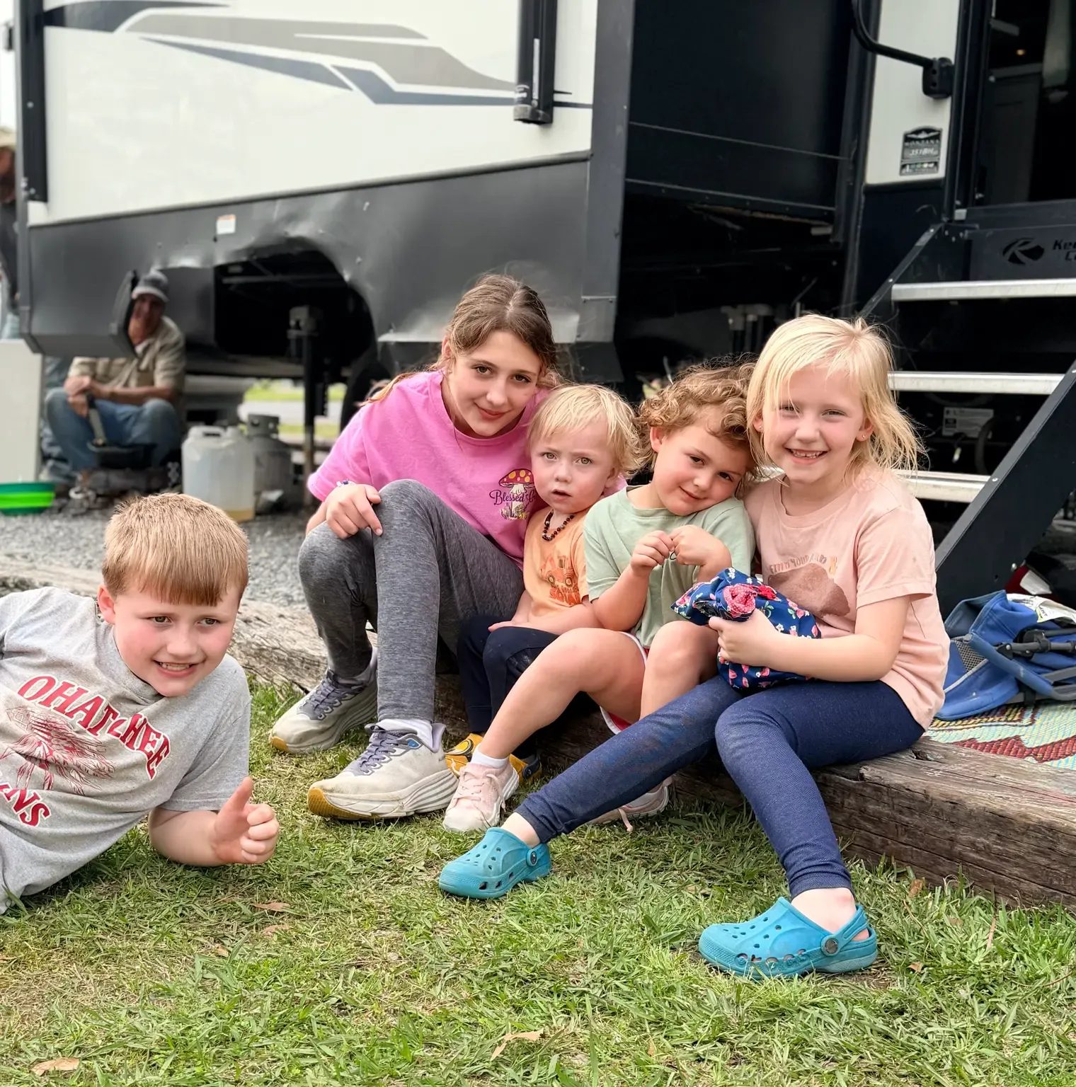 Five children spending time together outside an RV at Greensport RV Park & Marina.