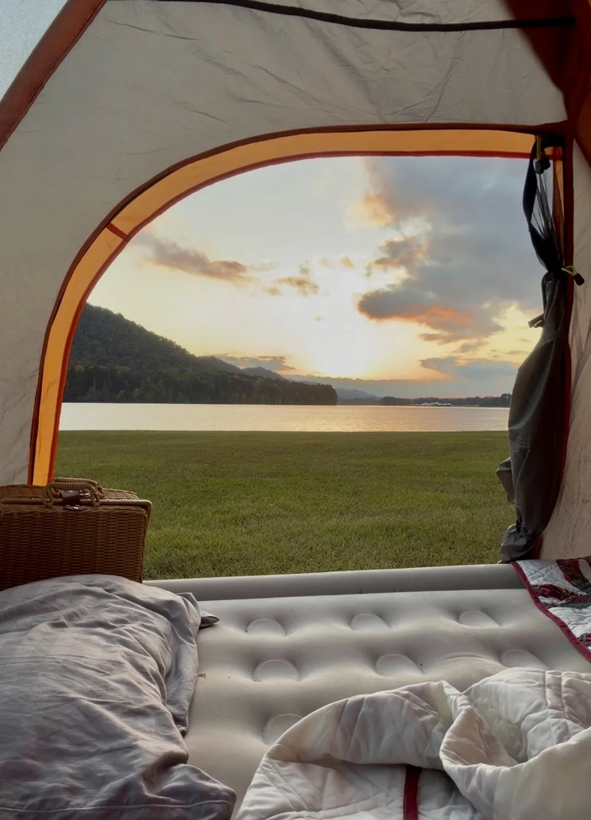 View of Neely Henry Lake at sunset from inside a waterfront tent