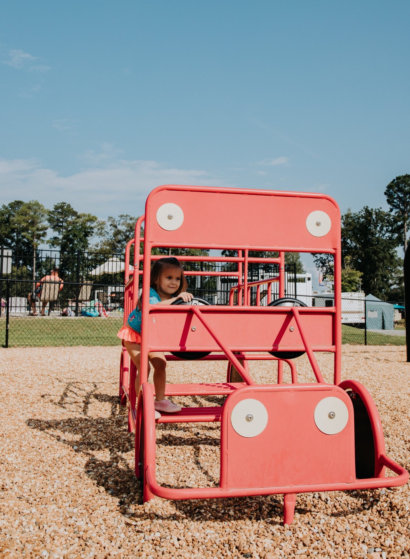 Child playing on the red truck at the playground