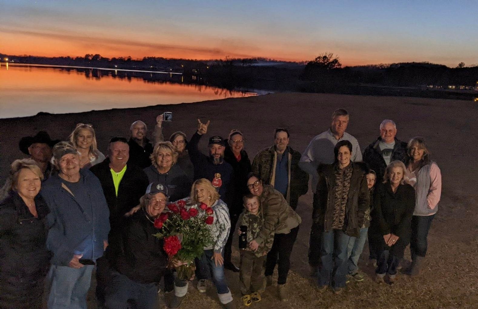 Greensport community gathering at the lake at sunset