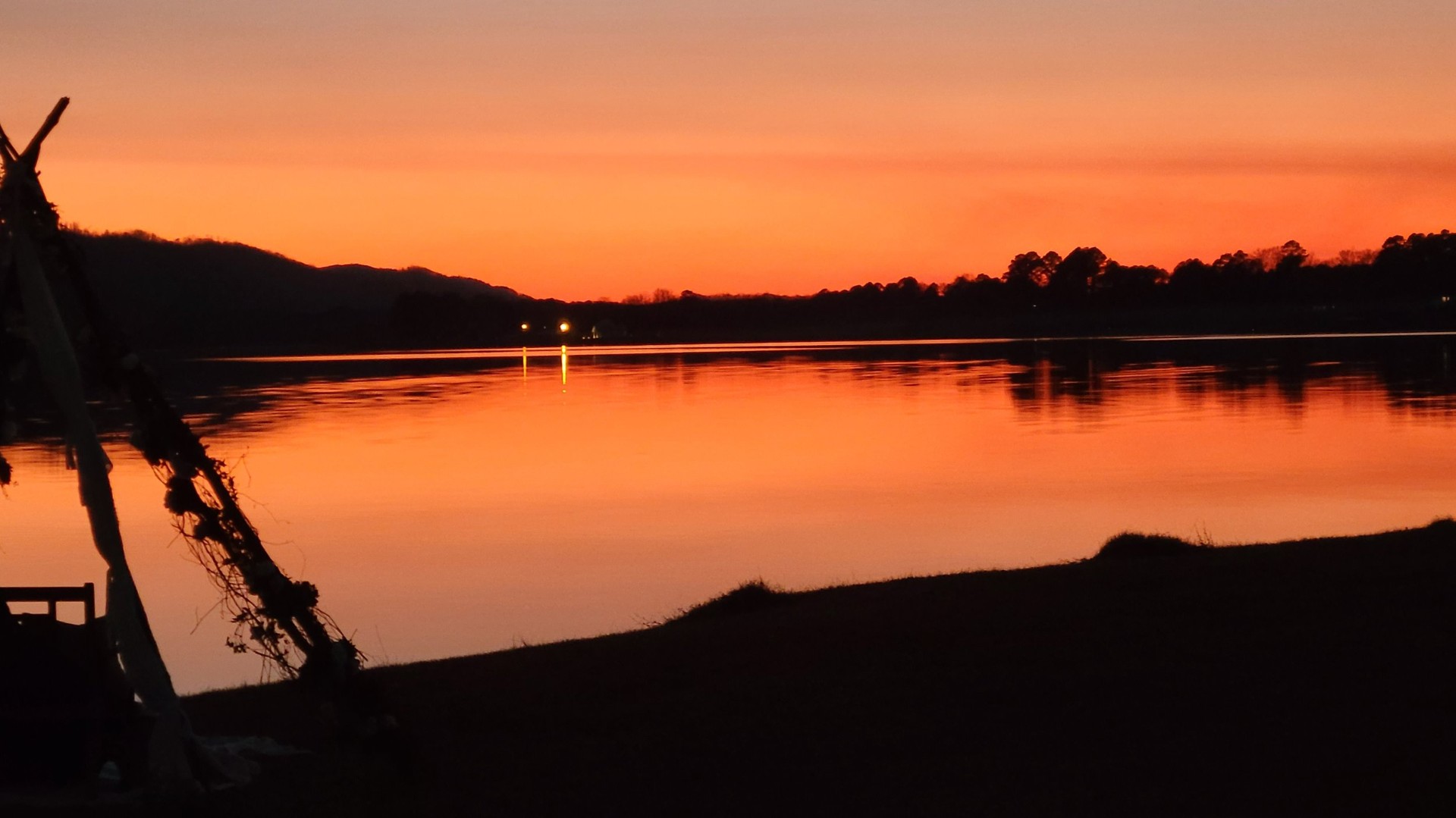 Orange sunset reflecting on calm water