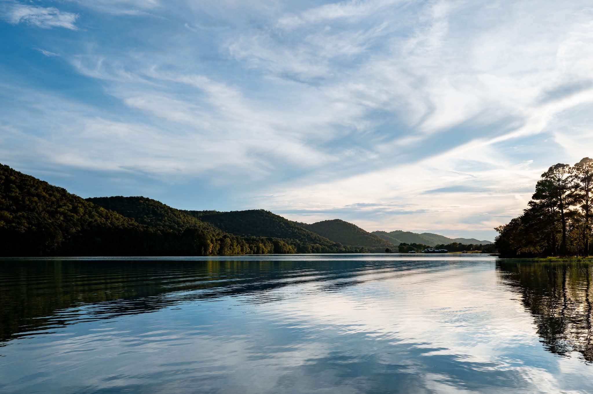 Calm Neely Henry Lake with forested foothills along the far shore at Greensport RV Park